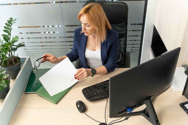 A person sitting at a desk, reviewing a document titled 
