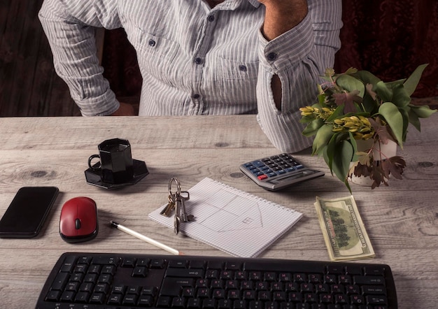 A person sitting at a desk reviewing documents related to Social Security benefits, with a calculator and pen nearby, emphasizing careful financial planning.