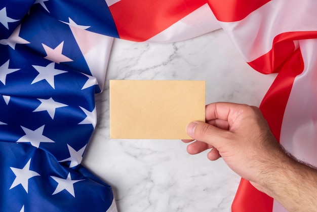 A close-up shot of a US veteran's hands holding a healthcare benefits card, with a blurred background of medical facilities and personnel. The focus is on the card and the veteran's hands, symbolizing access to healthcare and the tangible benefits available.