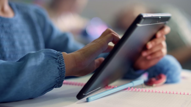 A close-up shot of a student using an adaptive learning software on a tablet, highlighting the personalized content and interactive interface. The focus is on the student's engaged expression and the software's data-driven insights.